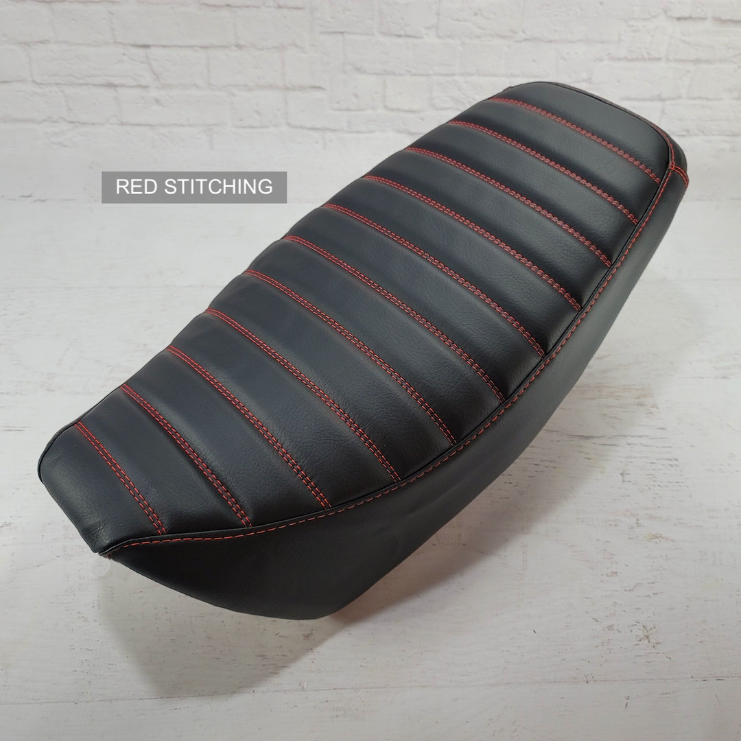 A black carbon fiber padded tuck and roll seat cover for a Honda Grom MSX125 with red stitching, displayed on a plain background.