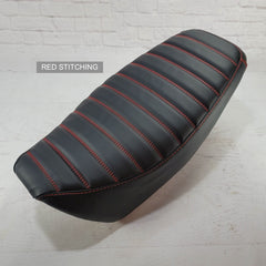 A black carbon fiber padded tuck and roll seat cover for a Honda Grom MSX125 with red stitching, displayed on a plain background.