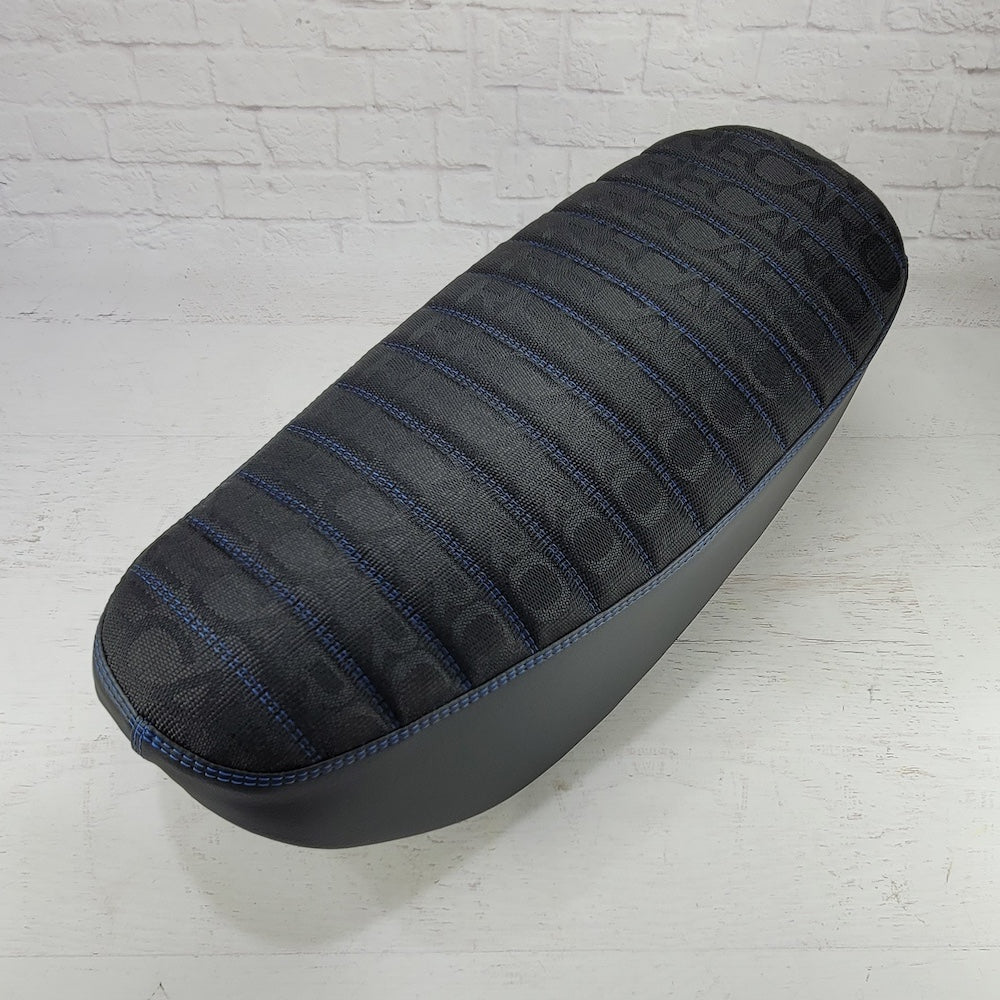 Black RECARO fabric Honda DAX 125 tuck-and-roll seat cover with deep blue stitching and piping, handmade by Cheeky Seats