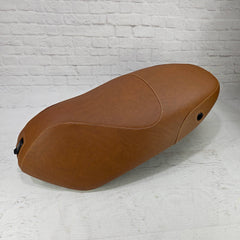 Cinnamon brown Piaggio Fly 2012–2020 seat cover with cream stitching and two fitted lock openings, handmade by Cheeky Seats