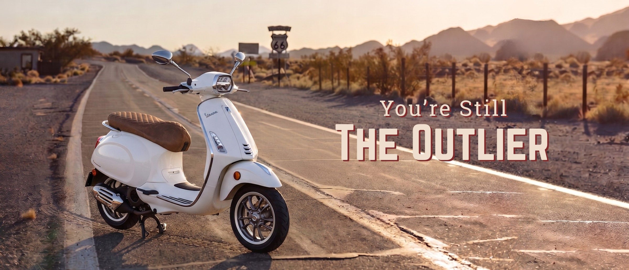 Cheeky Seats handmade scooter seat cover on a white Vespa on Route 66 with the message “You’re Still The Outlier”.
