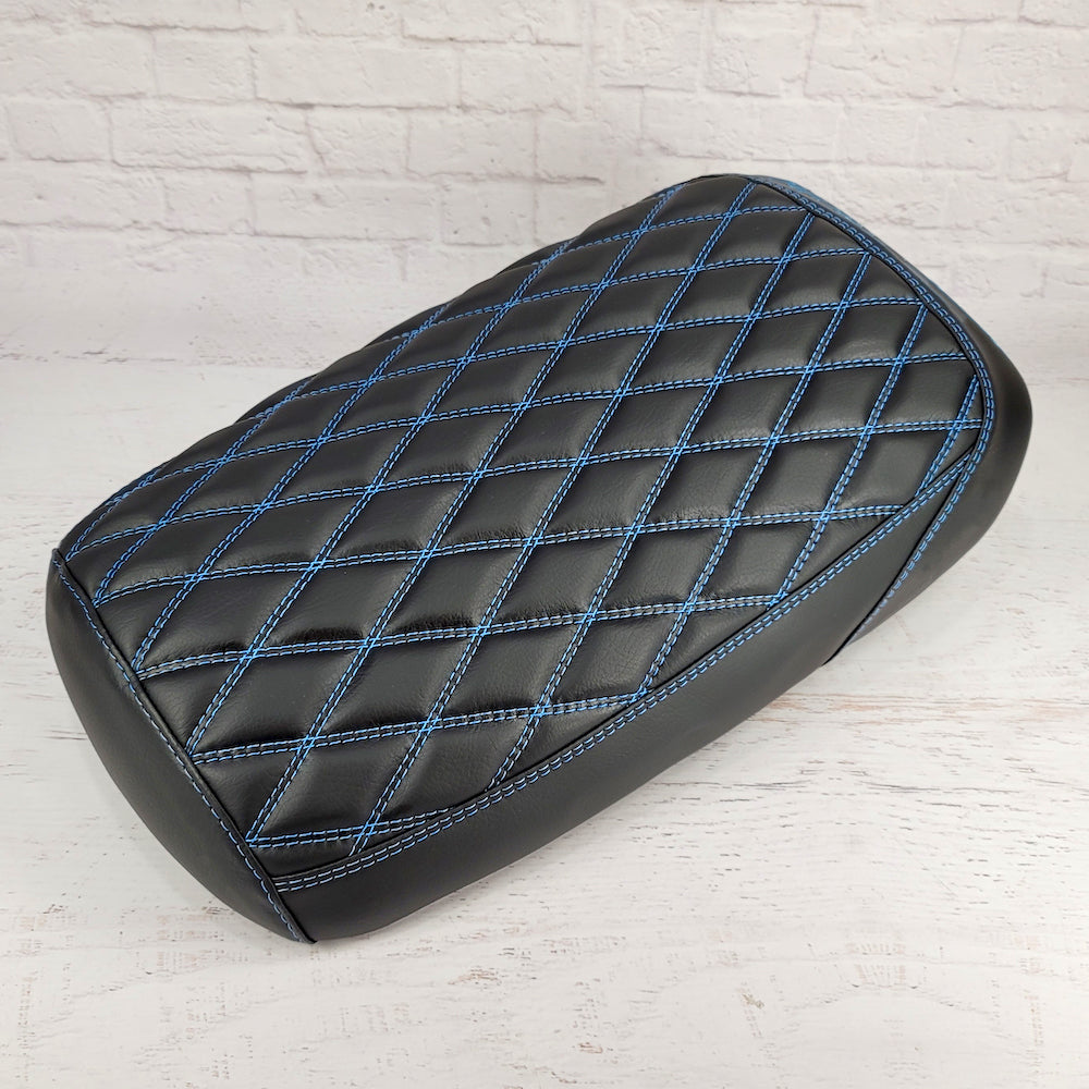 Matte black diamond-stitched Maddog seat cover with blue contrast stitching, handmade by Cheeky Seats