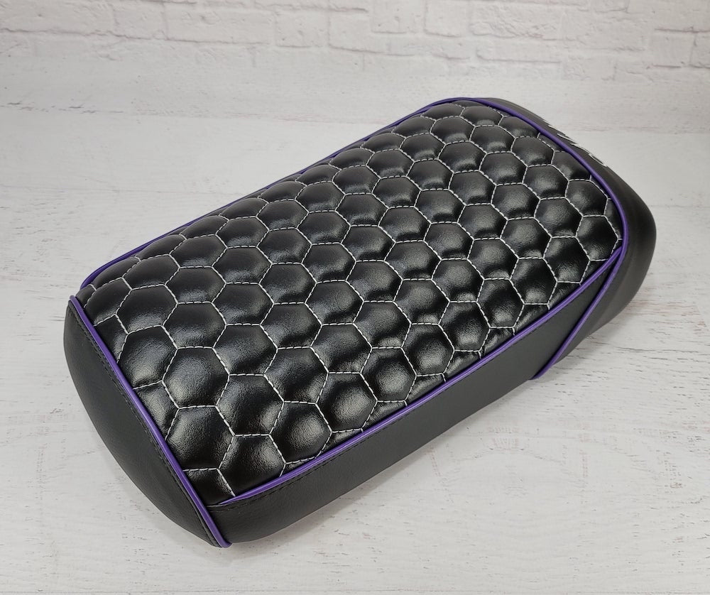 Black Maddog 50 / 150 hexagon honeycomb seat cover with purple piping and silver-gray stitching, showing the distinctive hex pattern, handmade by Cheeky Seats